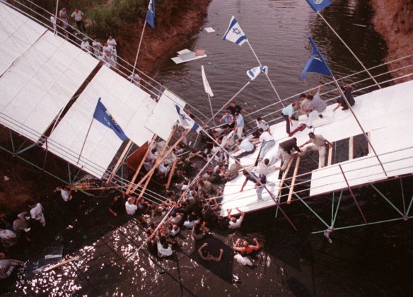 Israeli rescue workers evacuate members of the Australian Jewish athletic team from a bridge at the Yarkon River in Tel Aviv Monday, July 14, 1997.
