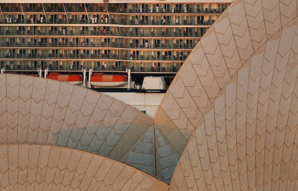 Cruise ship passengers on their balconies take in the view as their vessel passes the Opera House to dock at Circular Quay in 2012.