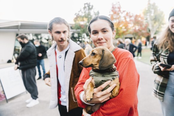 A woman takes her pet dachshund dog to the polling booth in Melbourne.