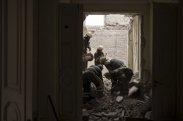 Emergency workers search for bodies under the debris of the regional administration building, heavily damaged after a Russian attack earlier this month in Kharkiv.