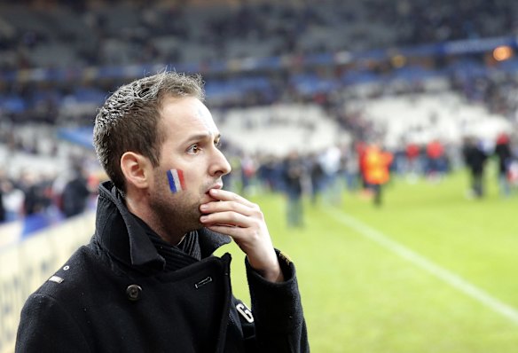 A French supporter is in disbelief after invading the pitch of the Stade de France stadium at the end of the international friendly soccer match between France and Germany.