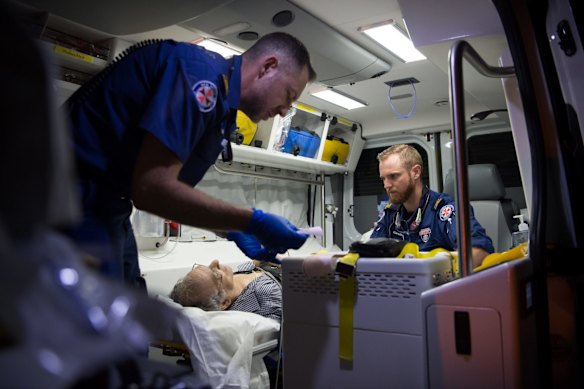 11:01pm. NSW Ambulance Paramedics Eugene Roser (left) and Gareth Garne work on a 70 year old male from Leichhardt who experienced loss of conciousness and low blood pressure. He was stabilised and transported to RPA Hospital.