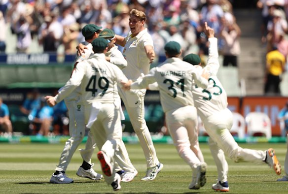 Cameron Green (C) of Australia celebrates with teammates after dismissing James Anderson of England and retaining the Ashes during day three of the Third Test match in the Ashes series between Australia and England at Melbourne Cricket Ground.
