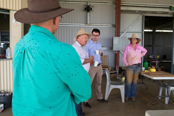 Minister for Agriculture and Water Resources David Littleproud in discussion with pilot Phil Owens, Tambo Mayor Andrew Martin and his wife, Louise Martin, during a furniture restoration workshop held at the Tambo racecourse in Tambo, Queensland.