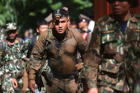 Thai soldiers searching for the missing children and their coach march out of the Tham Luang Nang Non cave in Mae Sai, Chiang Rai province, in northern Thailand