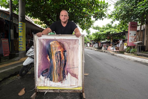 Multimillionaire entrepreneur Shane Yeend holds a painting by Myuran Sukumaran. 