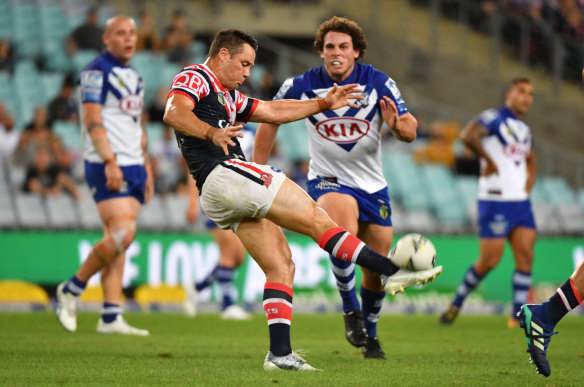 Roosters halfback Cooper Cronk puts in a clearing kick. 