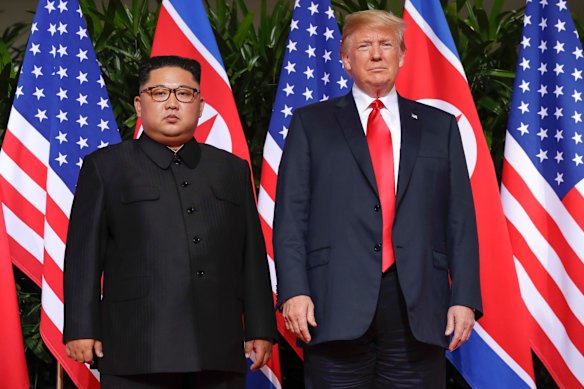 U. S. President Donald Trump stands with North Korea leader Kim Jong Un for a photograph at the Capella resort on Sentosa Island.