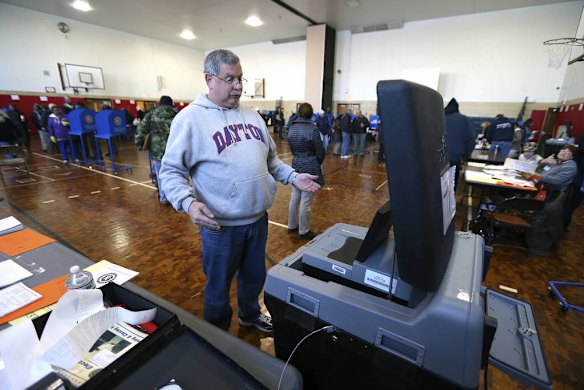 Ted Hommel reacts as the machine takes his ballot in New York