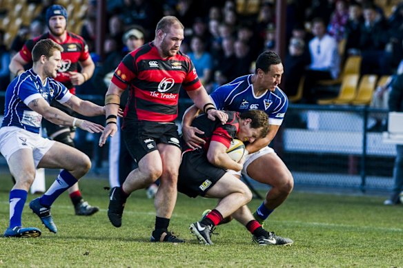 Royals Lausii Taliauli tackles Gunghalin's James Dargaville, a fellow ACT Brumbies teammate.