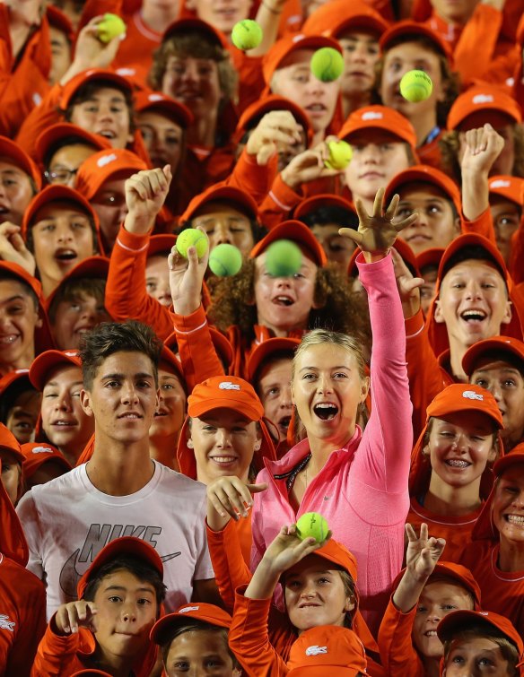 Thanasi Kokkinakis of Australia and Maria Sharapova of Russia pose for a photo with the ball kids of the Australian Open earlier this year.
