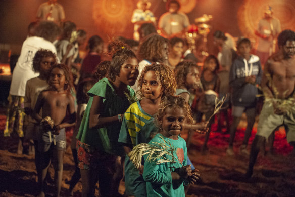 Children dance in the red dirt during the the first Djarmalak concert.