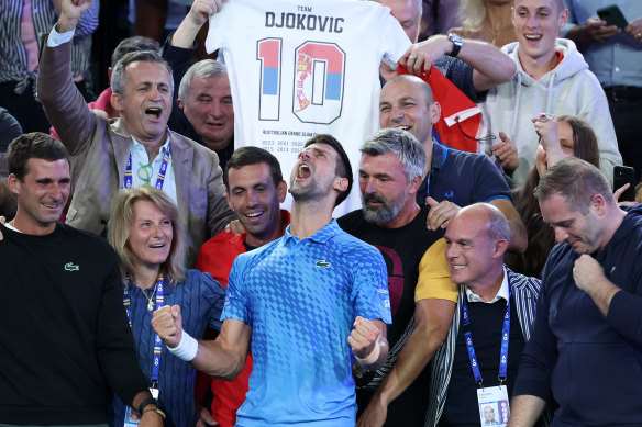 Novak Djokovic celebrates and behind him, one of his team holds up melbourne graphic t-shirt business,  Death By Zero’s t-shirt design.