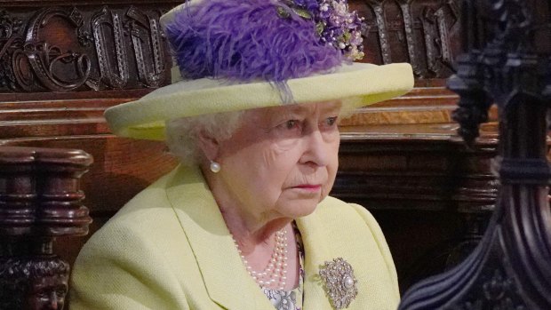 One is not amused: Queen Elizabeth II listens to Michael Curry.