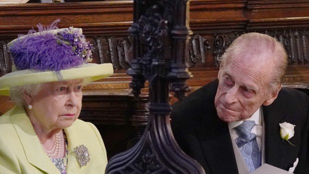 One is not amused: Queen Elizabeth II listens to Michael Curry.