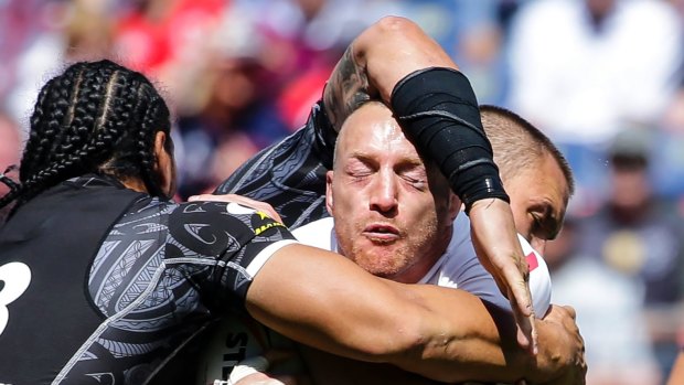 Grounded: New Zealand's  Taupau, left, makes a tackle in Denver.