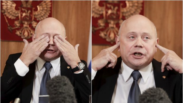 Russian Ambassador Grigory Logvinov gestures to reporters during a lengthy press conference in Canberra.