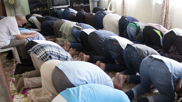 Muslim worshippers attend Friday prayers in a house alongside a mosque in Verulam, Durban South Africa.