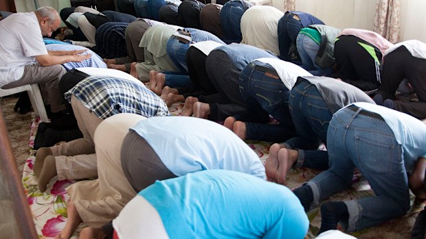 Muslim worshippers attend Friday prayers in a house alongside a mosque in Verulam, Durban South Africa.