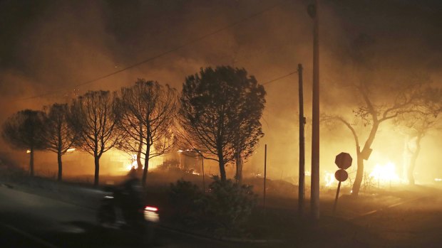 Buildings burn in the town of Mati.