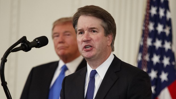 US President Donald Trump listens as Brett Kavanaugh, his Supreme Court nominee, speaks during an event in the East Room of the White House, Monday.