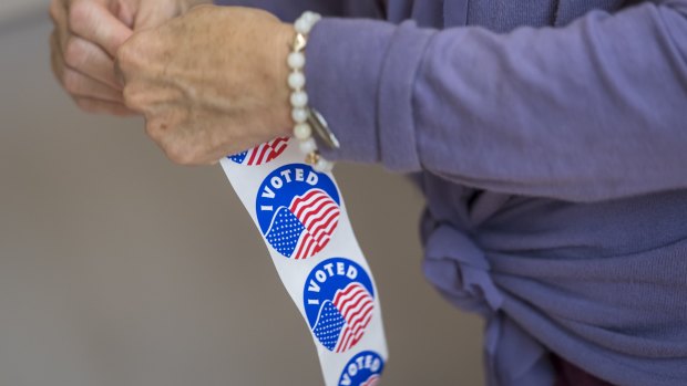 A voter peals off an "I Voted" sticker at a polling location in Larkspur, California, earlier this month.