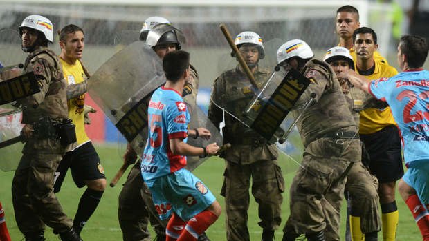 Players of Argentina's Arsenal clash with Brazil's anti-riot police at the end of the Copa Libertadores soccer match against Brazil's Atletico Mineiro.