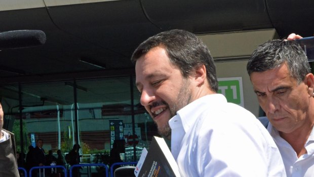 The League leader Matteo Salvini gets in a car as he arrives at Fiumicino airport near Rome.