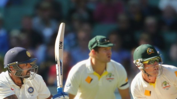 India opener Murali Vijay sweeps as Australia's Shane Watson (centre) look on late on day two of the Boxing Day Test.