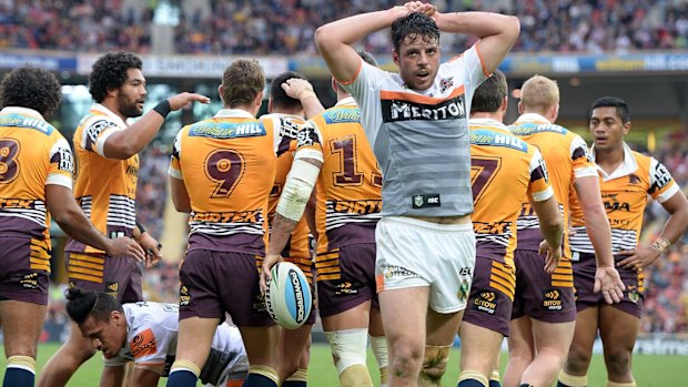 BRISBANE, AUSTRALIA - JULY 19:  Broncos players celebrate a try by Alex Glenn of the Broncos as Tigers players look dejected during the round 19 NRL match between the Brisbane Broncos and the Wests Tigers at Suncorp Stadium on July 19, 2015 in Brisbane, Australia.  (Photo by Bradley Kanaris/Getty Images)