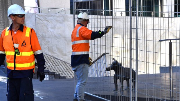 Larry La Trobe the dog statue is fenced in as scaffolding is placed around the perimeter of the City Square. The square will be closed for the next five years for the new rail tunnel.