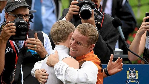 Golden Slipper-winning jockey Tommy Berry (right) gets a hug from his twin brother, fellow jockey Nathan, after his victory in the $3.5 million feature at Rosehill Gardens.