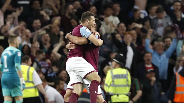 Final whistle: James Chester and Mile Jedinak embrace after Aston Villa confirmed their trip to Wembley.