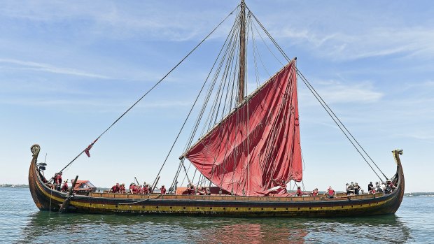 Crew members on the replica Viking ship Draken Harald Harfagre raise the ship's lone sail as they take a training cruise in Fishers Island Sound off Groton, Connecticut. 