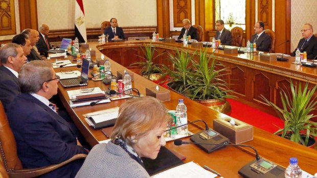 In this photo provided by Egypt's state news agency MENA, Egyptian President Abdel-Fattah el-Sissi, center left, convenes an emergency meeting of the National Security Council, the country's highest security body, following the early Thursday morning crash of an EgyptAir flight from Paris to Cairo with 66 passengers and crew on board, in Cairo, Egypt, Thursday, May 19, 2016. The council includes the prime minister and the defense, foreign and interior ministers, in addition to the chiefs of the intelligence agencies. (MENA via AP)
