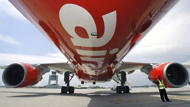 A security officer (R) stands by AirAsia aircraft.