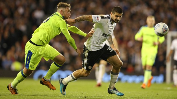 Fulham's Aleksandar Mitrovic (right) and Derby County's Richard Keogh battle for the ball.