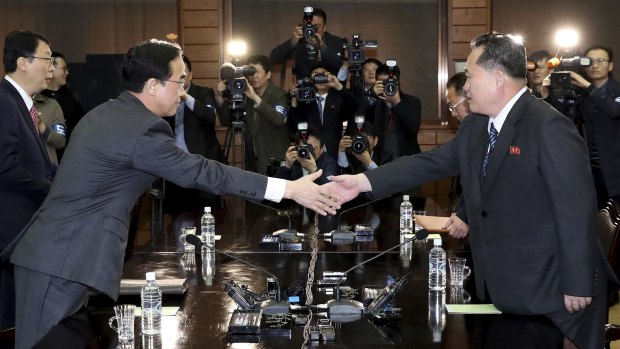 South Korean Unification Minister Cho Myoung-gyon, left, shakes hands with North Korean delegation head Ri Son-gwon before their meeting at the northern side of Panmunjom on Thursday.