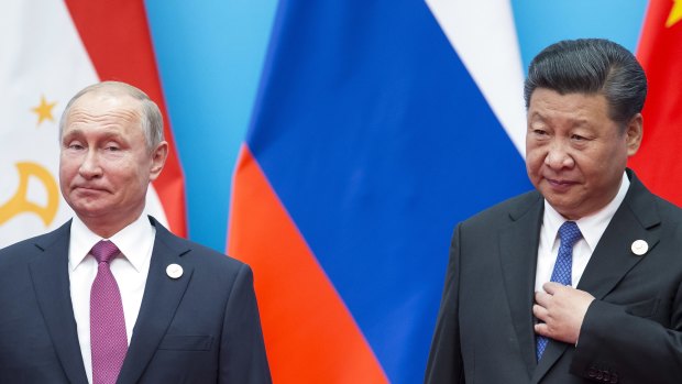 Chinese President Xi Jinping, right, and Russian President Vladimir Putin pose for a photo at the Shanghai Cooperation Organisation Summit in Qingdao in eastern China's Shandong Province.