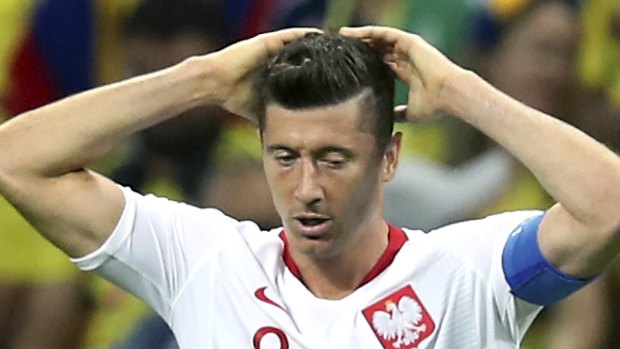 Poland's Robert Lewandowski cuts a forlorn figure during loss to Colombia.