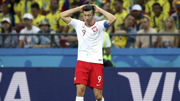 Poland's Robert Lewandowski cuts a forlorn figure during loss to Colombia.