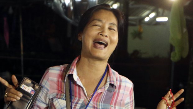 A family member smiles after hearing the news that the missing 12 boys and their soccer coach had been found, in Mae Sai, Chiang Rai province.