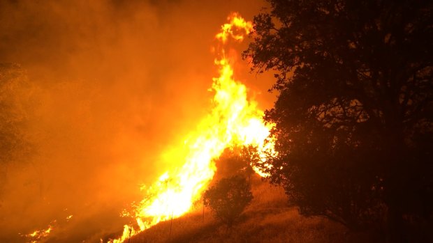 The Pawnee Fire wildfire burns northeast of Clearlake Oaks, California, on Sunday.