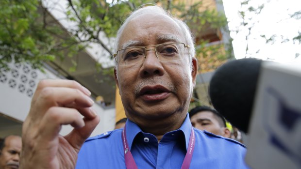 Malaysian Prime Minister Najib Razak talks to reporters after voting.