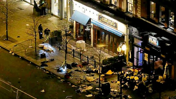 Investigators shine flashlights at one of the blast sites on Boylston Street near the finish line of the 2013 Boston Marathon.