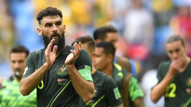 Honours even: Mile Jedinak applauds the crowd after the final whistle.