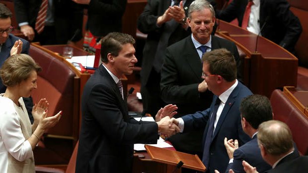 Senator James McGrath is congratulated by Senator Cory Bernardi after delivering his first speech. Photo: Alex Ellinghausen