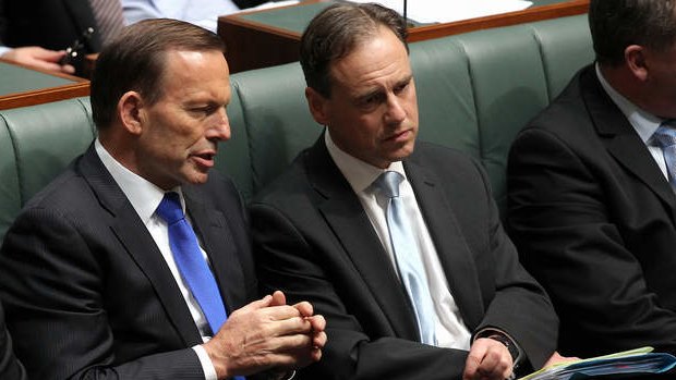 Prime Minister Tony Abbott and Environment Minister Greg Hunt in discussion during a division. Photo: Alex Ellinghausen