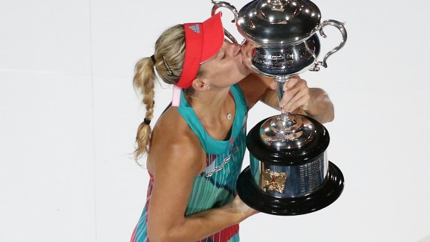 Angelique Kerber poses for photos with the trophy.