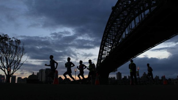 Entrants run under the Sydney Harbour Bridge in the Sydney Morning Herald half-marathon.